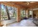 Enclosed sunroom with brick walls, tile flooring, and views of the backyard and lake at 50 Lake Dr # 1/2, Debary, FL 32713