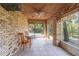 The enclosed sunroom features brick walls, tile floor and a view to the backyard and lake at 50 Lake Dr # 1/2, Debary, FL 32713