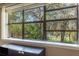 Window showcasing the vibrant green trees and Spanish moss draping from branches at 50 Lake Dr # 1/2, Debary, FL 32713
