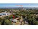 An aerial view of a quaint neighborhood near the Dunlawton Bridge featuring mature landscaping and a screened-in pool at 511 Powers Ave, Port Orange, FL 32127