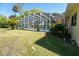 The backyard has a screened-in pool and well-maintained lawn at 511 Powers Ave, Port Orange, FL 32127