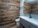 Modern bathroom featuring wood-look tile walls, sleek vanity, and contemporary fixtures at 511 Powers Ave, Port Orange, FL 32127