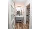 Stylish bathroom featuring a modern vanity, undermount sink, custom mirror, and elegant sliding barn door at 511 Powers Ave, Port Orange, FL 32127
