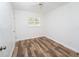 Bright bedroom with hardwood flooring, white walls, ceiling fan, and plenty of natural light from shuttered windows at 511 Powers Ave, Port Orange, FL 32127