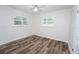 Bright bedroom with hardwood flooring, white walls, and plenty of natural light from shuttered windows at 511 Powers Ave, Port Orange, FL 32127