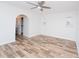 Bright bedroom with wood-look floors, white walls, and modern ceiling fan at 511 Powers Ave, Port Orange, FL 32127