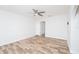 Bright bedroom featuring wood-look flooring, a ceiling fan, and white trim at 511 Powers Ave, Port Orange, FL 32127