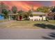 Charming yellow single-story home featuring well-maintained landscaping and mature palm trees in a desirable neighborhood at 511 Powers Ave, Port Orange, FL 32127