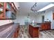 Open-concept kitchen featuring granite counters, custom cabinetry, and stainless appliances at 511 Powers Ave, Port Orange, FL 32127