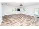 Open concept living room with new hardwood flooring, modern ceiling fan, and plenty of natural light at 511 Powers Ave, Port Orange, FL 32127