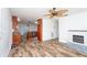 Open concept living room and kitchen featuring wood-look flooring and a fireplace at 511 Powers Ave, Port Orange, FL 32127