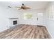 Cozy living room featuring a fireplace, modern flooring, and an abundance of natural light at 511 Powers Ave, Port Orange, FL 32127