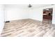 Spacious living room with hardwood flooring, open layout, and seamless flow into the kitchen at 511 Powers Ave, Port Orange, FL 32127