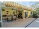 Covered patio with outdoor kitchen, grill, dining area, and retractable awning at 511 Powers Ave, Port Orange, FL 32127