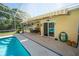 The spacious pool deck includes an awning and outdoor dining area at 511 Powers Ave, Port Orange, FL 32127