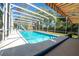 A crystal-clear pool is enclosed within a screened-in patio and a slide at 511 Powers Ave, Port Orange, FL 32127