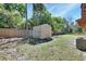 Large backyard features a shed and wood fence with mature trees at 530 Taylor Dr, Orange City, FL 32763