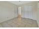 Bedroom with neutral walls, tile flooring, and closet space for storage at 530 Taylor Dr, Orange City, FL 32763
