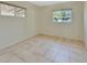 Neutral bedroom with tile flooring and windows offering natural light at 530 Taylor Dr, Orange City, FL 32763