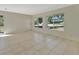 Spacious living room with neutral tile flooring, bright lighting, and large windows at 530 Taylor Dr, Orange City, FL 32763