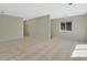Open living space features neutral tile flooring, and natural lighting from a window at 530 Taylor Dr, Orange City, FL 32763