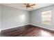 Bedroom featuring hardwood floors, a ceiling fan, a window, and light-grey walls at 69 Grey Dapple Way, Ormond Beach, FL 32174