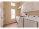 Laundry room equipped with cabinets, counter space, sink and a modern washer and dryer at 69 Grey Dapple Way, Ormond Beach, FL 32174
