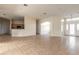 Spacious living room with tile floors seamlessly connects to the kitchen area at 69 Grey Dapple Way, Ormond Beach, FL 32174