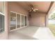Covered patio with a ceiling fan, an entry door, and glass sliding doors leading indoors at 69 Grey Dapple Way, Ormond Beach, FL 32174