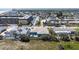 Aerial view showcasing a brightly colored home with outdoor seating, beach access, and a pool at 7 Kathy Dr, Ormond Beach, FL 32176