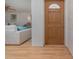 Warm entryway with wood-look floors and a glimpse into the living area, promoting a welcoming atmosphere at 7 Kathy Dr, Ormond Beach, FL 32176