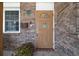 Charming front door with decorative glass, and colorful potted flowers at 7 Kathy Dr, Ormond Beach, FL 32176