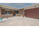 Inviting front porch with seating area leads to a brick home with a 2 car garage at 7 Kathy Dr, Ormond Beach, FL 32176