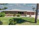 Charming brick home featuring a manicured front lawn and beautifully landscaped garden beds with white rock at 7 Kathy Dr, Ormond Beach, FL 32176