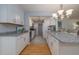 Bright kitchen featuring granite countertops, stainless appliances, and ample cabinet space at 7 Kathy Dr, Ormond Beach, FL 32176