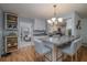 Open kitchen with a large granite island, white cabinets, and modern light fixture at 7 Kathy Dr, Ormond Beach, FL 32176
