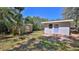 Spacious backyard featuring storage shed, newly installed door, and a tiled patio area at 709 Cedar St, Daytona Beach, FL 32114