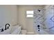 Bathroom featuring a white vanity, toilet, and a shower with modern black and white patterned tiling at 709 Cedar St, Daytona Beach, FL 32114