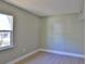 Bedroom with natural light, featuring neutral walls, wood grain floors and window to backyard at 709 Cedar St, Daytona Beach, FL 32114
