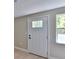 Bright entryway featuring a charming front door, sleek flooring, and freshly painted walls at 709 Cedar St, Daytona Beach, FL 32114