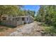 Exterior view of the house featuring a long driveway and mature shade trees at 709 Cedar St, Daytona Beach, FL 32114