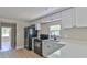Well-equipped kitchen boasts white cabinets, stainless steel appliances, and a breakfast bar at 709 Cedar St, Daytona Beach, FL 32114