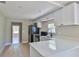 Well-equipped kitchen boasts white cabinets, stainless steel appliances, and a breakfast bar at 709 Cedar St, Daytona Beach, FL 32114