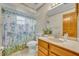 Bathroom featuring a vanity sink, a toilet, and a shower with decorative curtain at 715 Oak Ter, Orange City, FL 32763