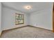 Bedroom with neutral carpet, large window, and light fixture at 715 Oak Ter, Orange City, FL 32763