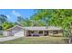 Charming single-story home with attached garage, brick accents, and well-maintained front lawn at 715 Oak Ter, Orange City, FL 32763