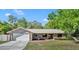 Inviting single-story home with a neutral color palette, attached garage, and tidy landscaping at 715 Oak Ter, Orange City, FL 32763