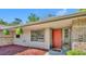 Close-up of the front entrance with a brightly colored door, brick accents, and attractive plants at 715 Oak Ter, Orange City, FL 32763