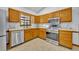 Well-equipped kitchen featuring stainless steel appliances, wooden cabinets, and neutral countertops at 715 Oak Ter, Orange City, FL 32763
