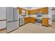 Well-lit kitchen featuring stainless steel appliances, wood cabinets, and a window overlooking the backyard at 715 Oak Ter, Orange City, FL 32763